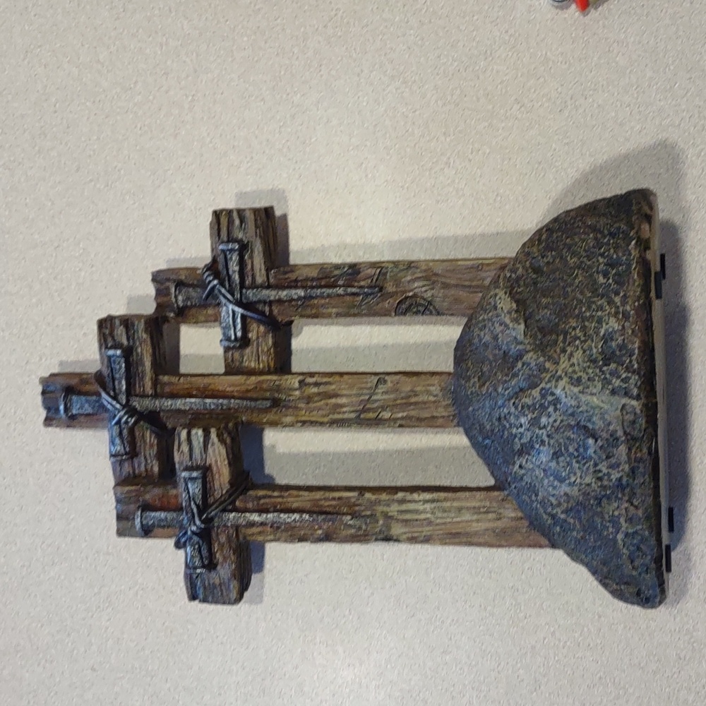 Wooden cross on rock decor
